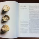 Kusshi Oysters Information - Fresh BC oysters holding a book open